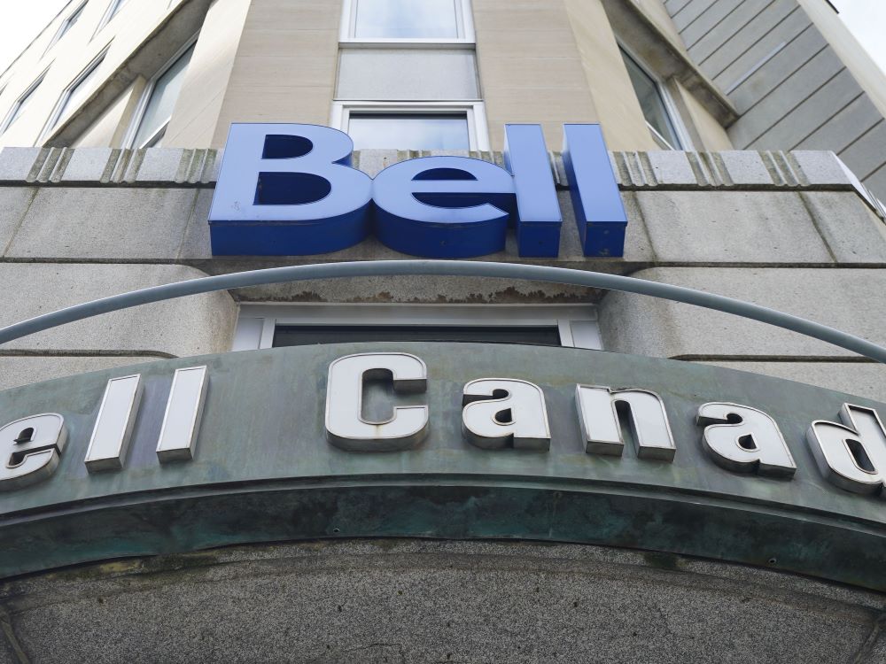 A grey office building rises into the sky. On the facade are logos that say ‘Bell’ in blue letters and ‘Bell Canada’ in grey.