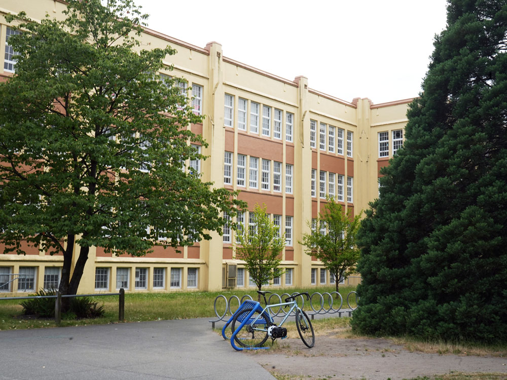 The exterior of a three-storey school building in Vancouver. The building is nearly 100 years old.