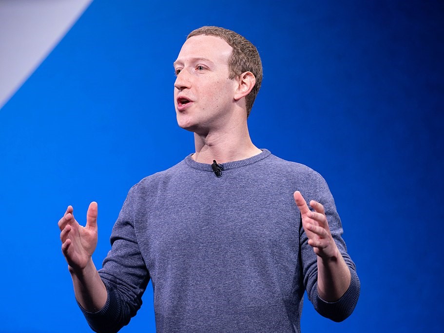 A middle-aged man, Facebook and Meta founder Mark Zuckerberg, speaks and gestures with his hands.